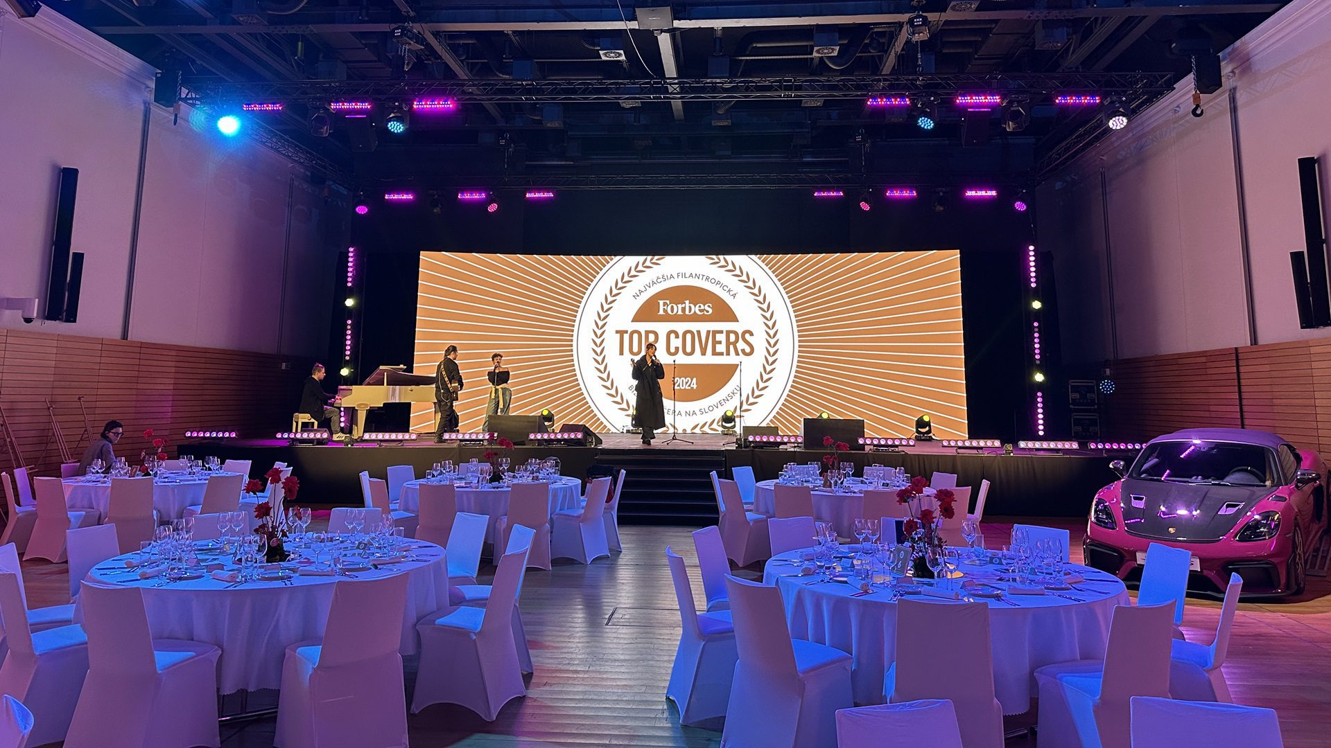 Elegantná udalosť s osvetleným pódiom a stolmi