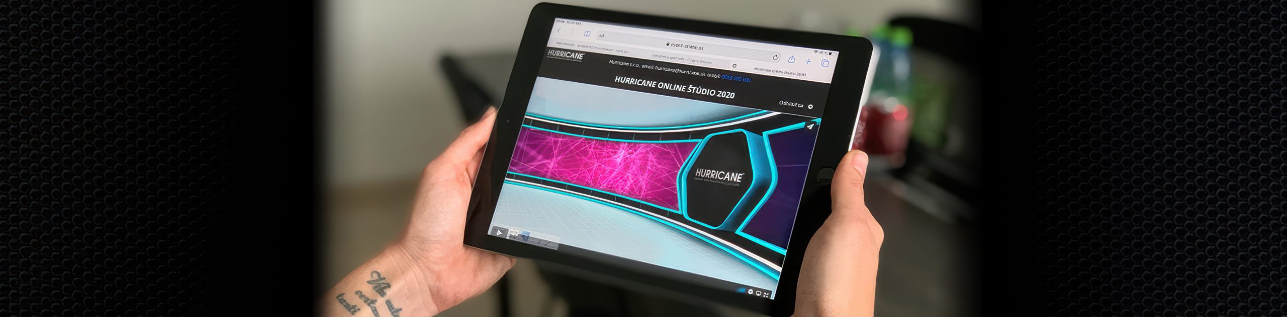 A person holds a tablet with digital graphics displayed.
